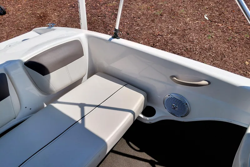Slide: The Image of 2021 Bayliner 160 Bowrider interior with cushioned seating and speaker detail. - 26