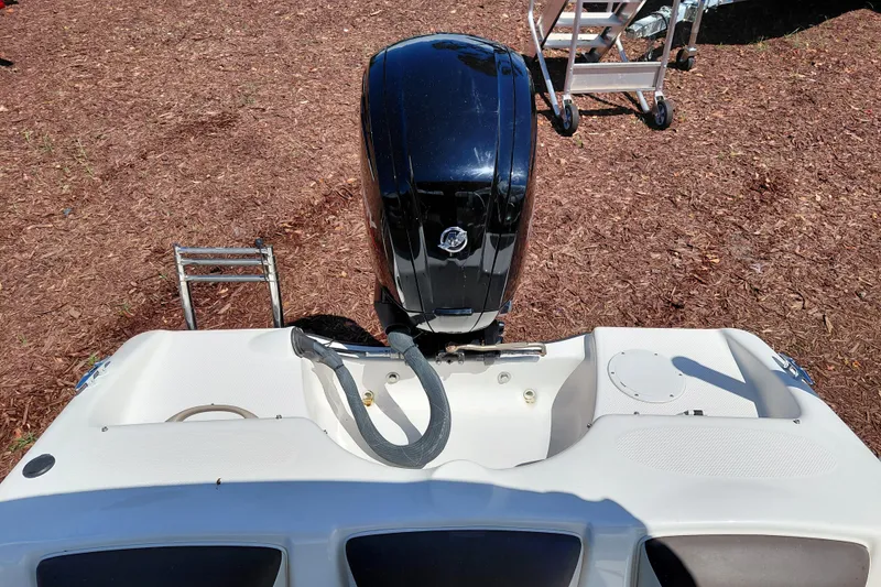 Slide: The Image of 2021 Bayliner 160 Bowrider boat with outboard motor and ladder on dry ground. - 27