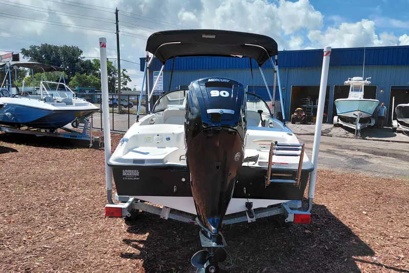 Slide: The Image of 2021 Bayliner 160 Bowrider with Mercury 90 engine, parked outdoors at a marina. - 6