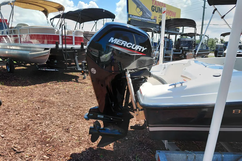 Slide: The Image of 2021 Bayliner 160 Bowrider with Mercury outboard motor, displayed outdoors. - 9