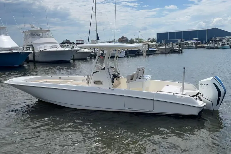 The Image of 2020 Boston Whaler 270 Dauntless boat docked in a marina, featuring sleek design and powerful engine. - 0