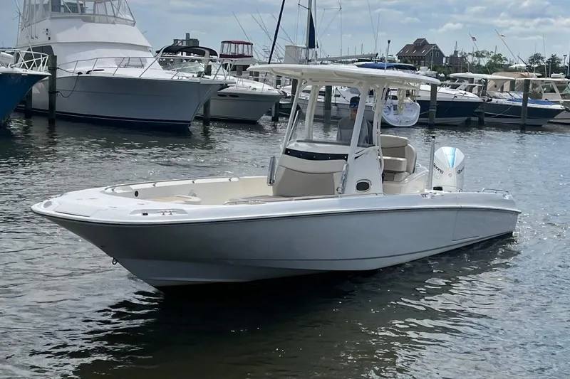 Slide: The Image of 2020 Boston Whaler 270 Dauntless boat docked in a marina with other vessels. - 3