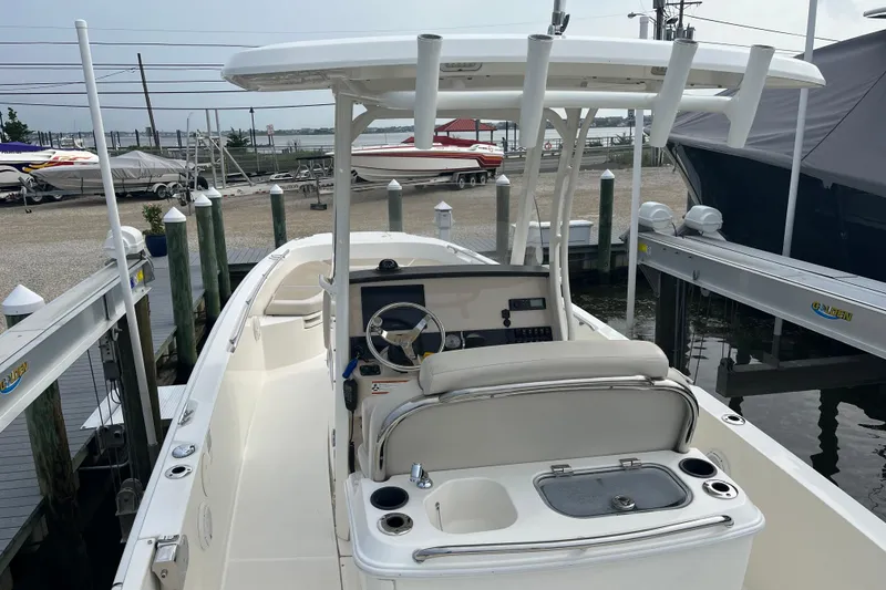 Slide: The Image of 2020 Boston Whaler 270 Dauntless boat docked, showcasing helm and seating area. - 4