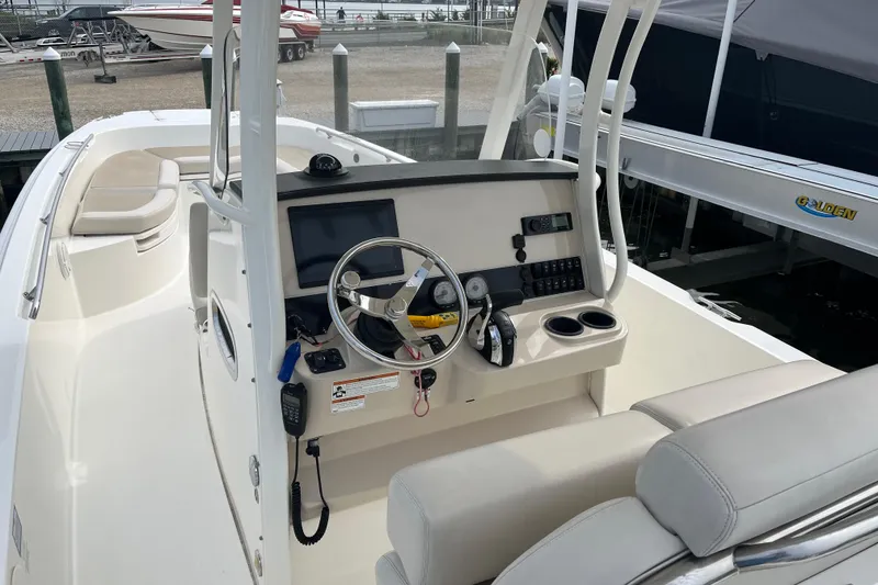 Slide: The Image of 2020 Boston Whaler 270 Dauntless boat interior with steering console and seating. - 5
