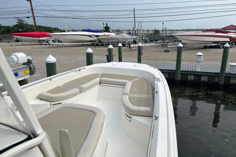Slide: The Image of 2020 Boston Whaler 270 Dauntless boat docked, featuring spacious seating and sleek design. - 6