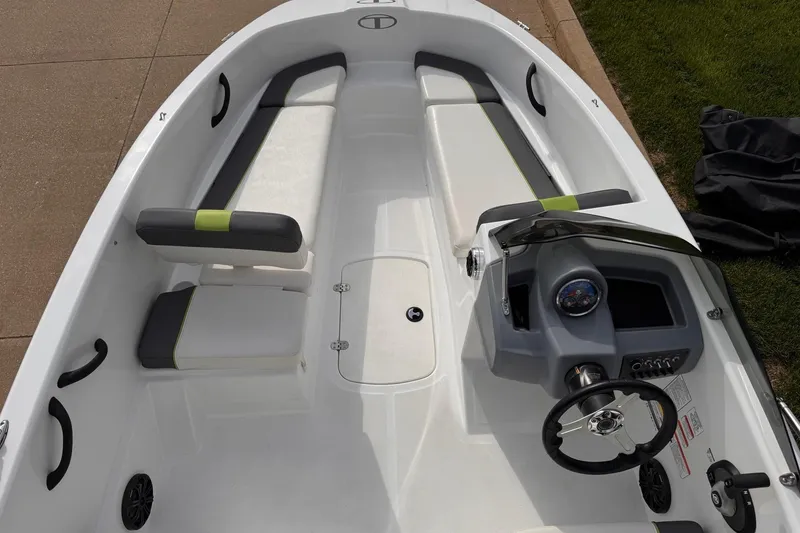 Slide: The Image of 2021 Tahoe T16 boat interior with seating and steering console, showcasing modern design. - 1