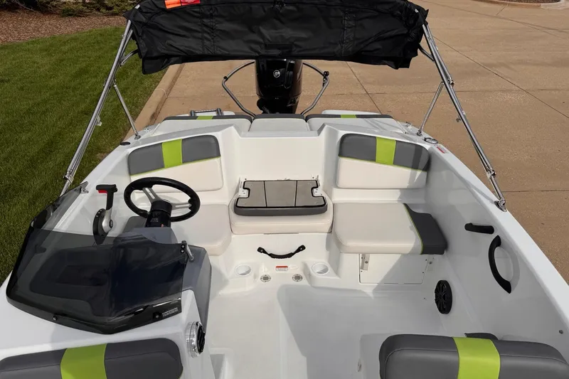 Slide: The Image of 2021 Tahoe T16 boat interior with seating, steering wheel, and canopy. - 3