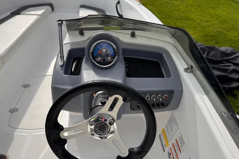 Slide: The Image of Steering console of a 2021 Tahoe T16 boat with gauges and controls. - 4