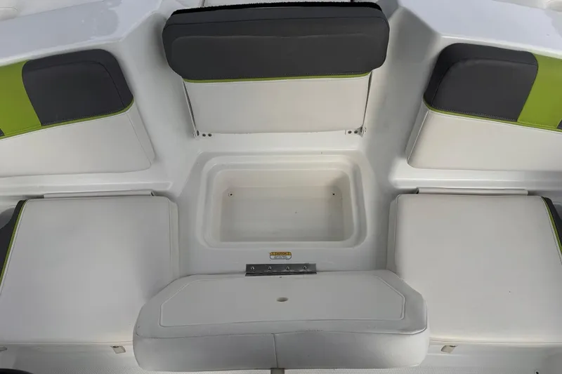 Slide: The Image of 2021 Tahoe T16 boat interior with white and green cushioned seating. - 6