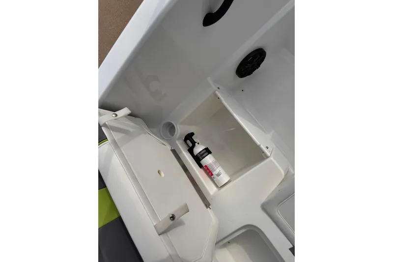 Slide: The Image of Interior of 2021 Tahoe T16 boat showing storage compartment with fire extinguisher. - 7