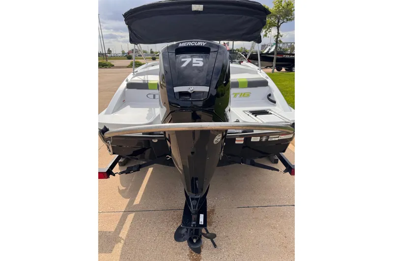 Slide: The Image of 2021 Tahoe T16 boat with Mercury 75 engine, rear view on pavement. - 8
