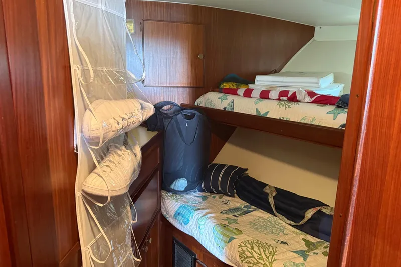 Slide: The Image of Cozy cabin interior of 1985 Hatteras 52 Convertible with bunk beds and shoe organizer. - 10