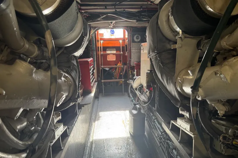Slide: The Image of Engine room of a 1985 Hatteras 52 Convertible yacht, showcasing machinery and equipment. - 13