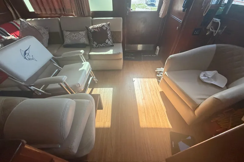 Slide: The Image of Interior of 1985 Hatteras 52 Convertible yacht with comfortable seating and wooden flooring. - 15