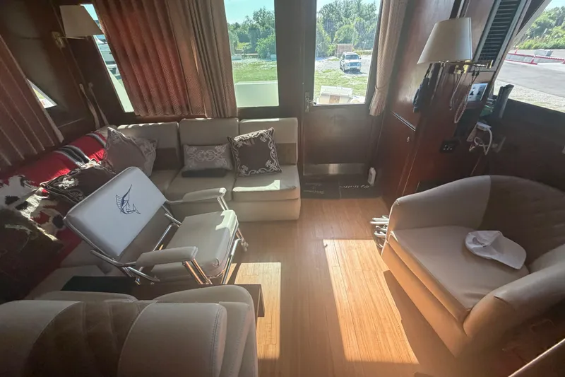 Slide: The Image of Interior of 1985 Hatteras 52 Convertible yacht with cozy seating and natural light. - 16