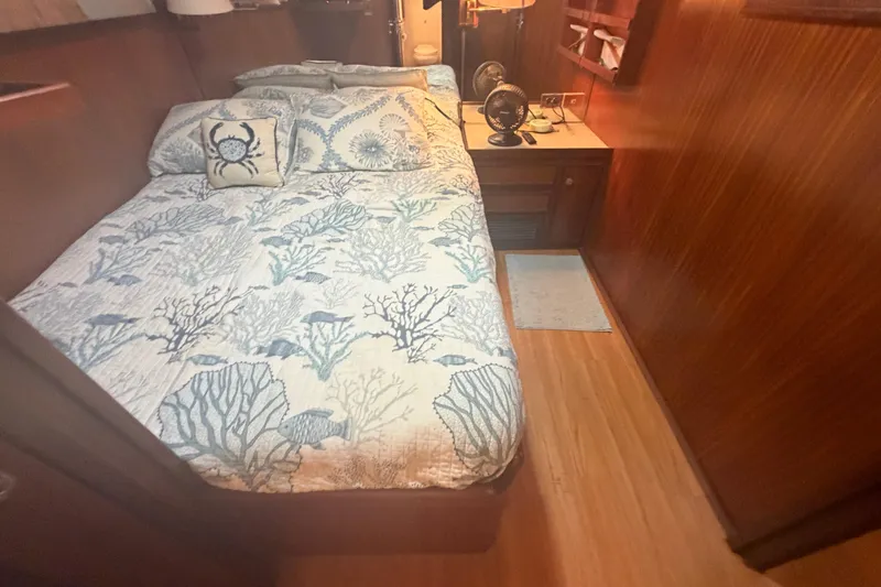 Slide: The Image of Cozy bedroom interior of 1985 Hatteras 52 Convertible yacht with nautical-themed bedding. - 19
