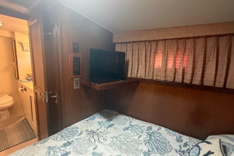 Slide: The Image of Cozy cabin interior of 1985 Hatteras 52 Convertible yacht with TV and bathroom. - 20