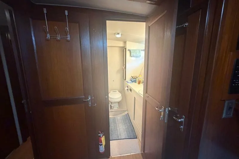 Slide: The Image of Interior view of 1985 Hatteras 52 Convertible yacht bathroom with wooden doors. - 21
