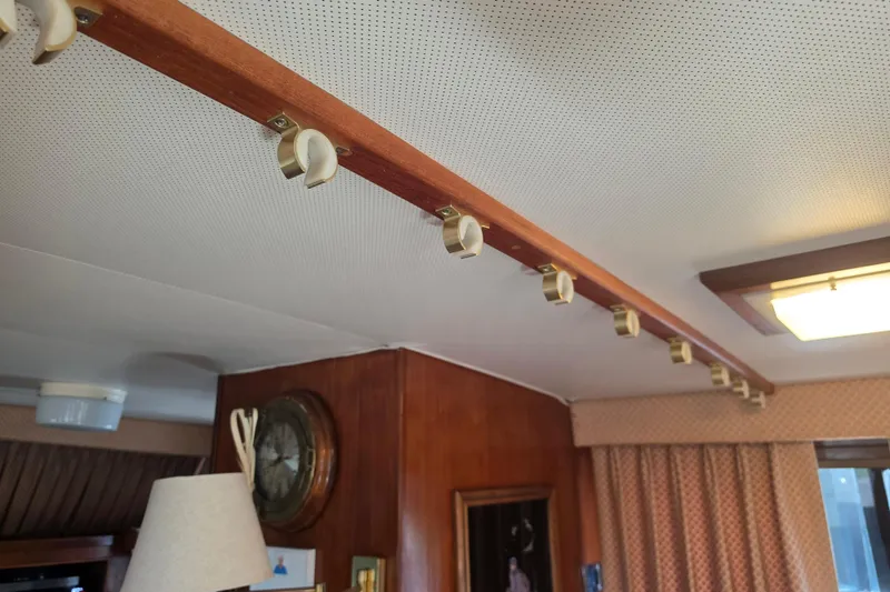 Slide: The Image of Bathroom sink area on a 1985 Hatteras 52 Convertible yacht, featuring toiletries and a mirror. - 23