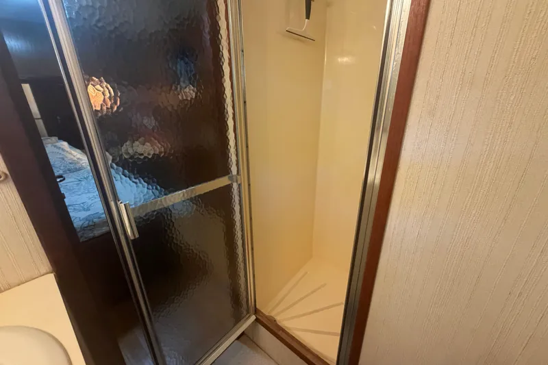 Slide: The Image of Shower area inside 1985 Hatteras 52 Convertible yacht with textured glass door. - 26