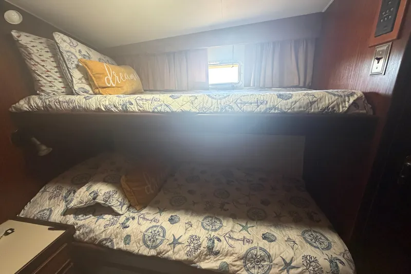 Slide: The Image of Bunk beds in 1985 Hatteras 52 Convertible yacht cabin with nautical-themed bedding. - 27