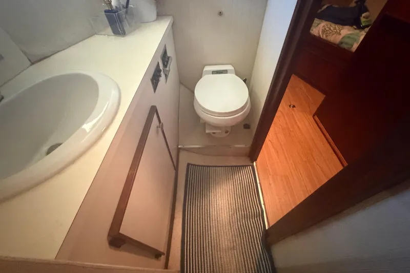 Slide: The Image of Bathroom interior of 1985 Hatteras 52 Convertible yacht with sink and toilet. - 30