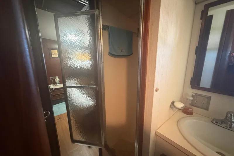 Slide: The Image of Interior of 1985 Hatteras 52 Convertible yacht showing bathroom with shower and sink. - 31