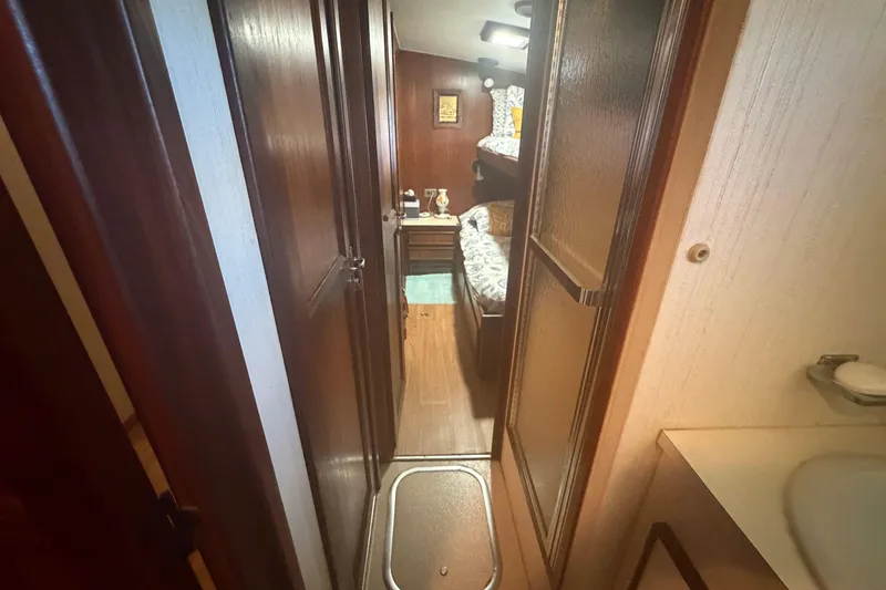 Slide: The Image of Interior of 1985 Hatteras 52 Convertible yacht, featuring cozy wooden cabin with bunk beds. - 32