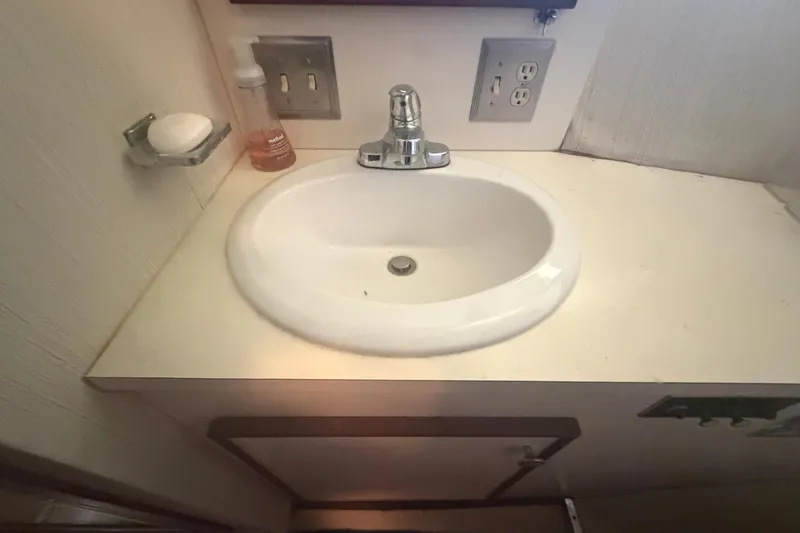 Slide: The Image of Bathroom sink area on a 1985 Hatteras 52 Convertible yacht. - 33