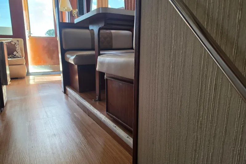 Slide: The Image of Interior of 1985 Hatteras 52 Convertible yacht with wooden flooring and seating area. - 39