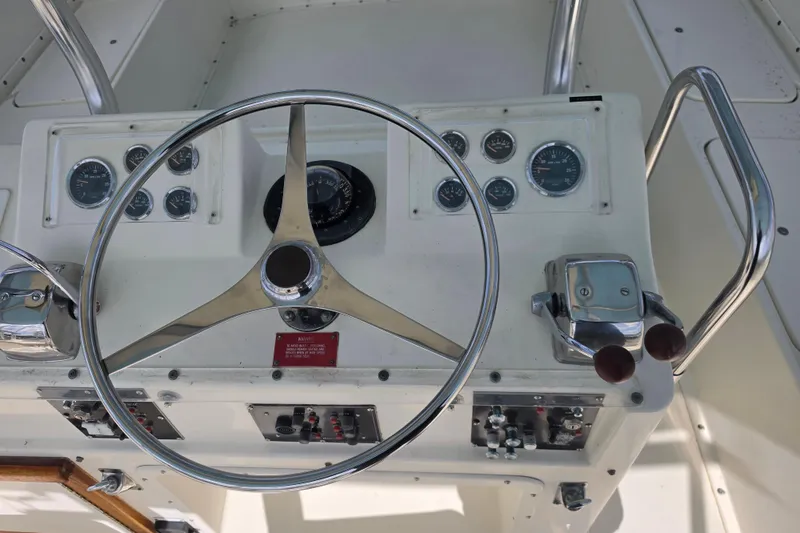 Slide: The Image of Steering console of a 1985 Hatteras 52 Convertible yacht with gauges and controls. - 43