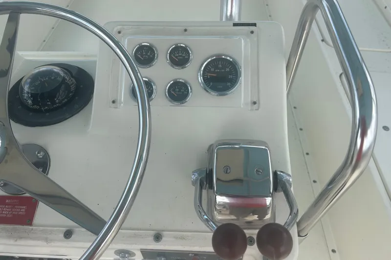 Slide: The Image of Helm of 1985 Hatteras 52 Convertible with gauges and steering wheel. - 44