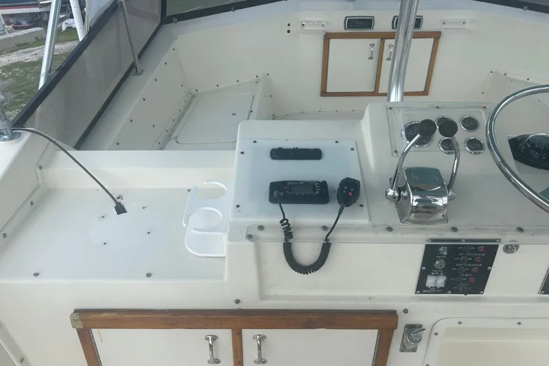 Slide: The Image of Cockpit of 1985 Hatteras 52 Convertible yacht with steering wheel and control panel. - 47