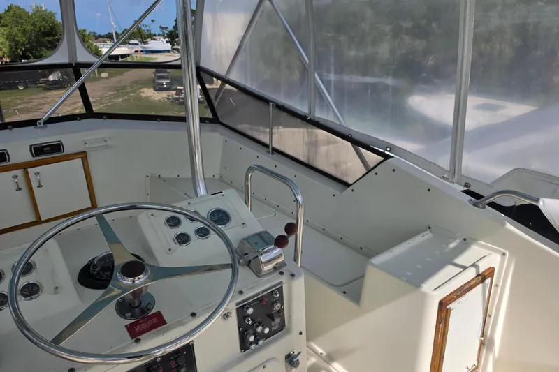 Slide: The Image of Interior view of 1985 Hatteras 52 Convertible yacht helm with steering wheel and controls. - 48