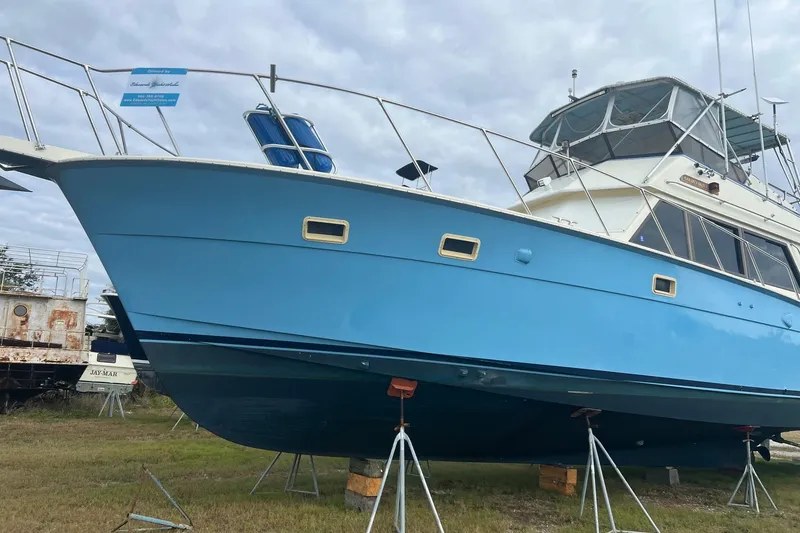 Slide: The Image of 1985 Hatteras 52 Convertible yacht on stands, blue hull, outdoor display. - 5