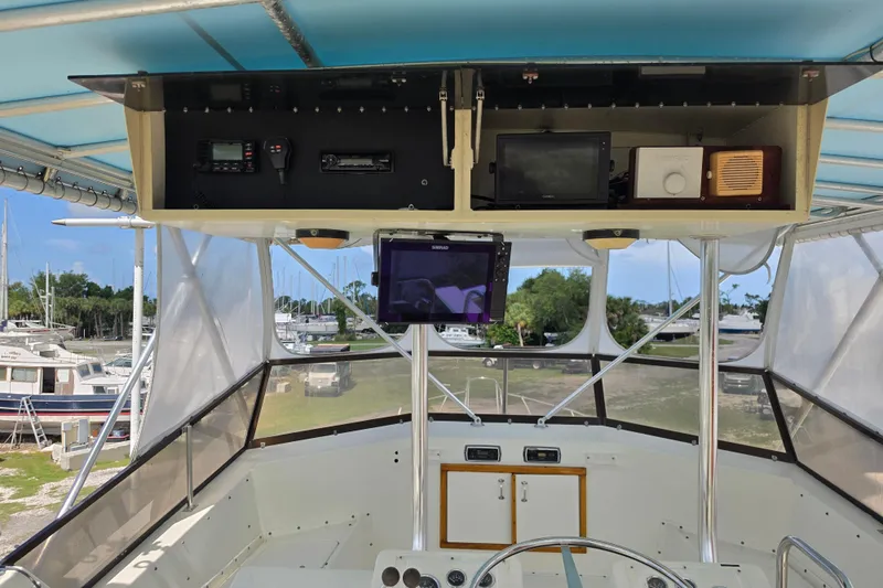 Slide: The Image of Cockpit view of a 1985 Hatteras 52 Convertible yacht with navigation equipment. - 51