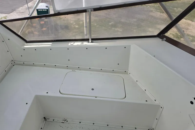 Slide: The Image of Interior view of a 1985 Hatteras 52 Convertible boat with seating and storage. - 53