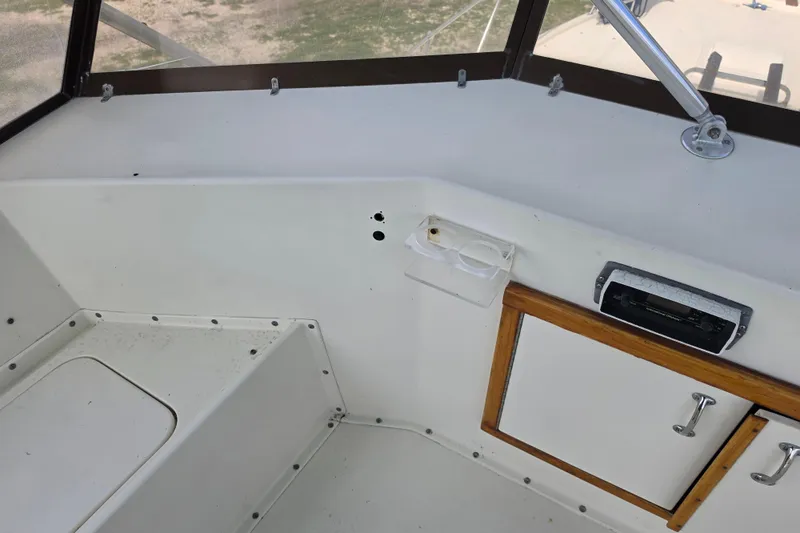 Slide: The Image of Interior view of a 1985 Hatteras 52 Convertible boat cockpit area. - 54