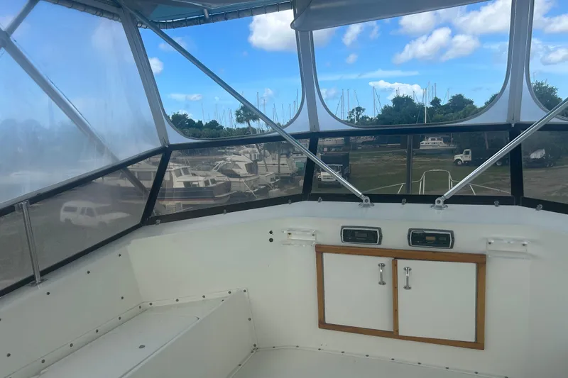 Slide: The Image of Interior view of 1985 Hatteras 52 Convertible yacht with marina background. - 55