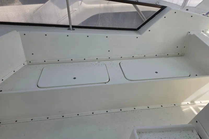 Slide: The Image of Interior seating area of 1985 Hatteras 52 Convertible boat with storage compartments. - 59