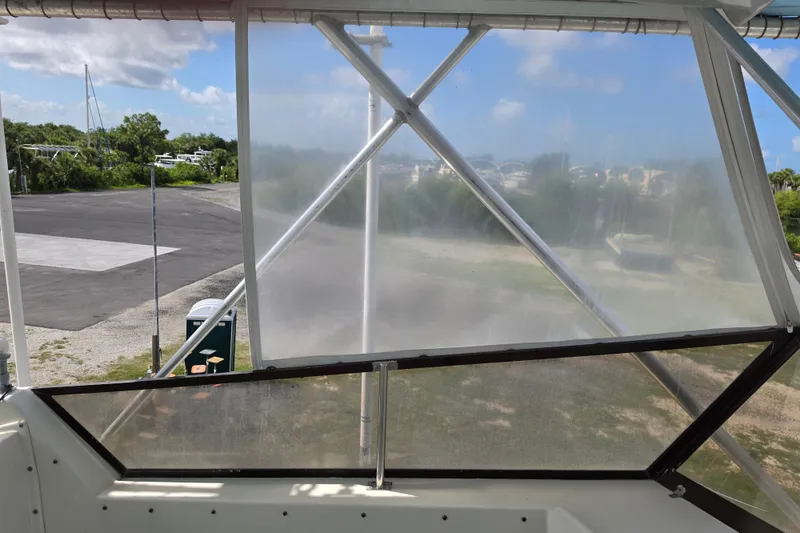 Slide: The Image of View from the 1985 Hatteras 52 Convertible boat, showcasing clear enclosure panels. - 60