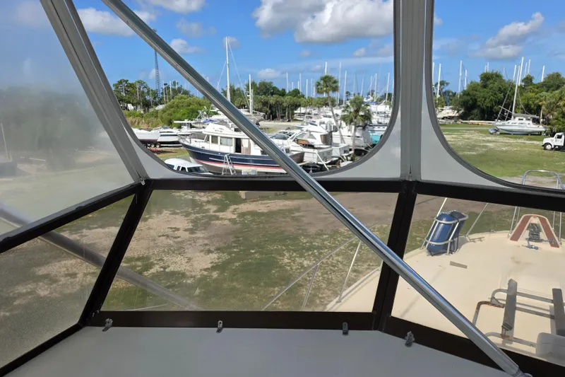 Slide: The Image of View from 1985 Hatteras 52 Convertible yacht, overlooking marina with boats and trees. - 61