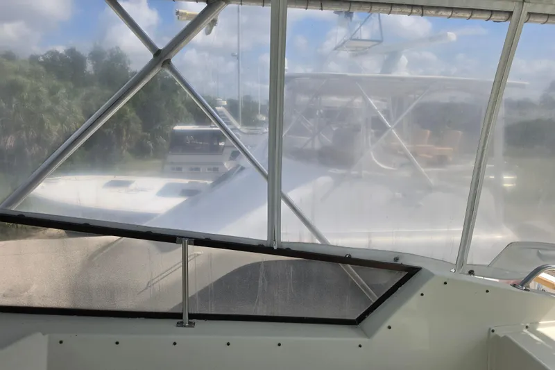 Slide: The Image of 1985 Hatteras 52 Convertible yacht view through cockpit enclosure. - 62