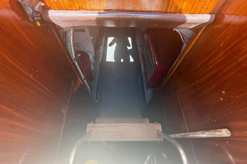 Slide: The Image of Interior view of 1985 Hatteras 52 Convertible boat, showing wooden stairs and equipment. - 65