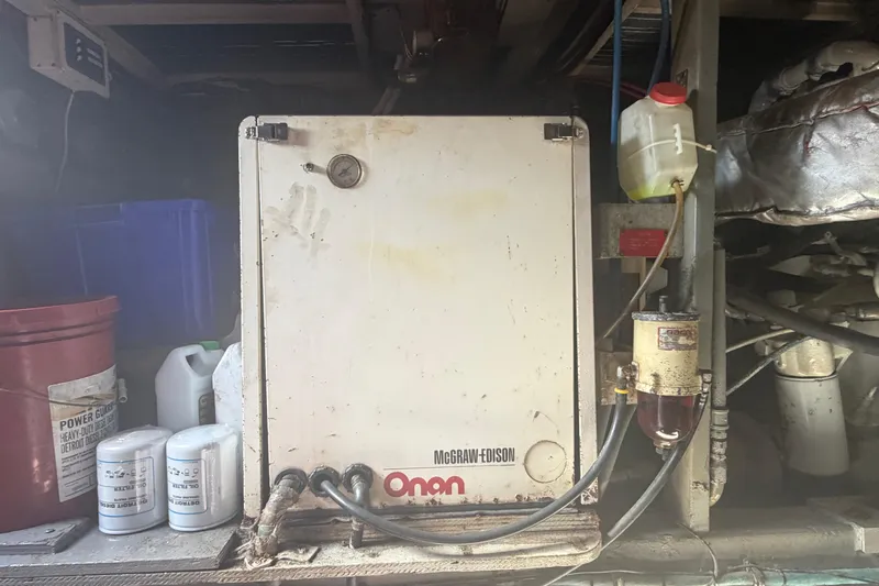 Slide: The Image of Engine room of 1985 Hatteras 52 Convertible with Onan generator and maintenance supplies. - 68
