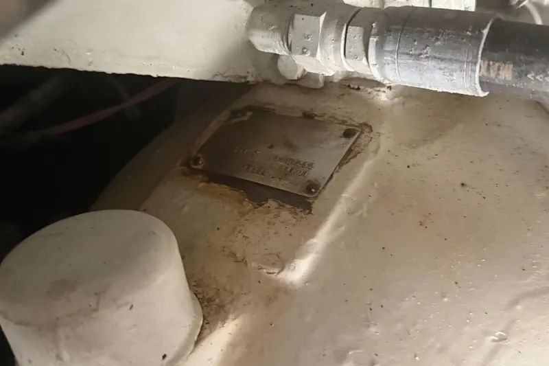 Slide: The Image of Engine component of 1985 Hatteras 52 Convertible boat with visible metal plate. - 69