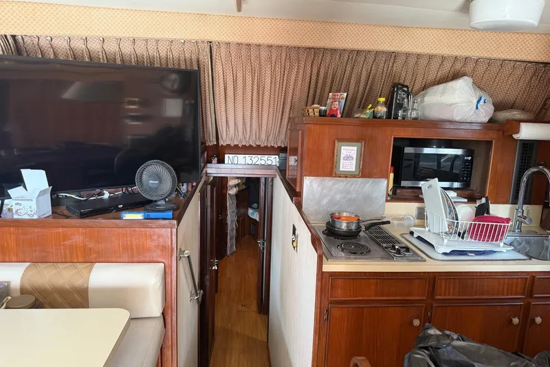 Slide: The Image of Interior of 1985 Hatteras 52 Convertible yacht with kitchen and living area. - 7