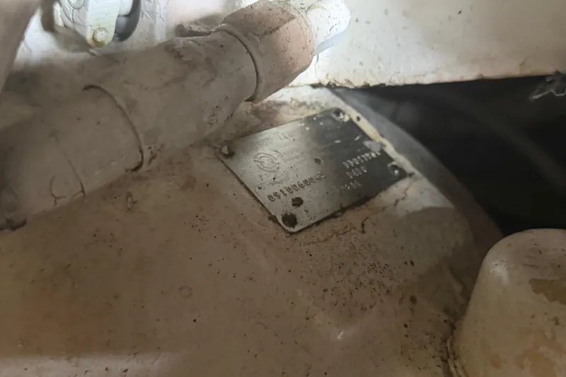 Slide: The Image of Engine compartment of a 1985 Hatteras 52 Convertible with visible metal identification plate. - 70