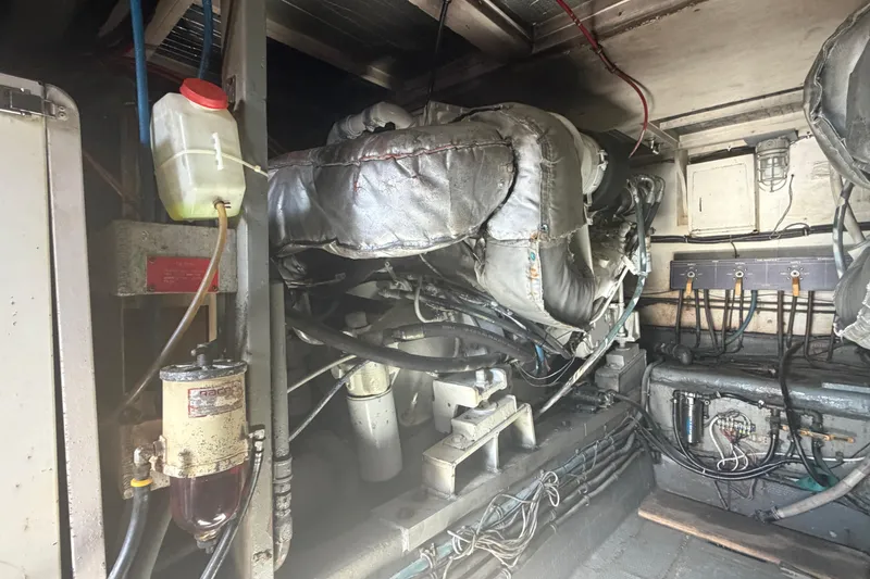 Slide: The Image of Engine room of a 1985 Hatteras 52 Convertible yacht, showcasing machinery and components. - 73