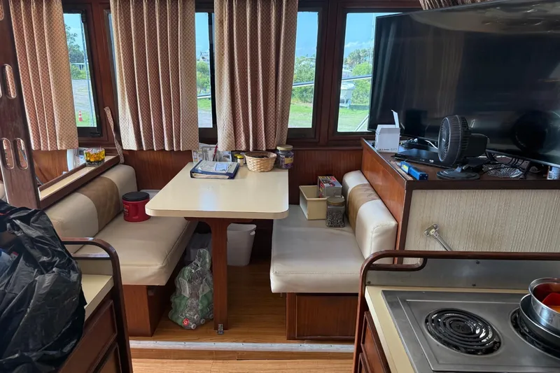 Slide: The Image of Interior of a 1985 Hatteras 52 Convertible yacht with dining area and kitchen. - 8
